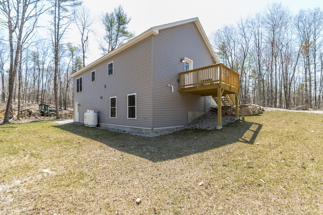 view of property exterior featuring a lawn, stairs, and a deck