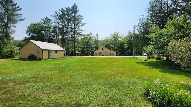 1898 Roxbury Rd, Roxbury, ME 04275 - view of grassy yard with view of scattered trees and an outbuilding