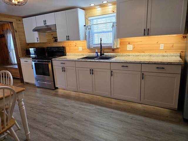 1898 Roxbury Rd, Roxbury, ME 04275 - kitchen featuring a sink, electric stove, under cabinet range hood, wood finished floors, and wooden walls