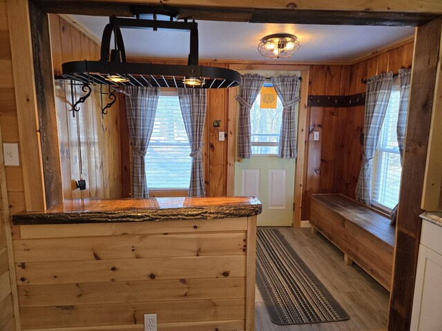 1898 Roxbury Rd, Roxbury, ME 04275 - kitchen with light wood-style floors and wood walls