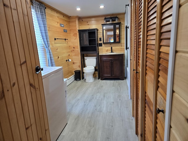 1898 Roxbury Rd, Roxbury, ME 04275 - bathroom with vanity, toilet, wood finished floors, wooden walls, and baseboard heating