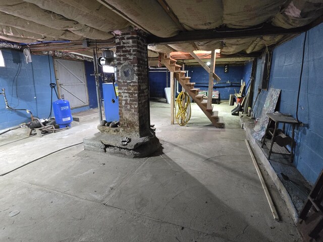 1898 Roxbury Rd, Roxbury, ME 04275 - unfinished basement featuring a water pressure tank and stairs