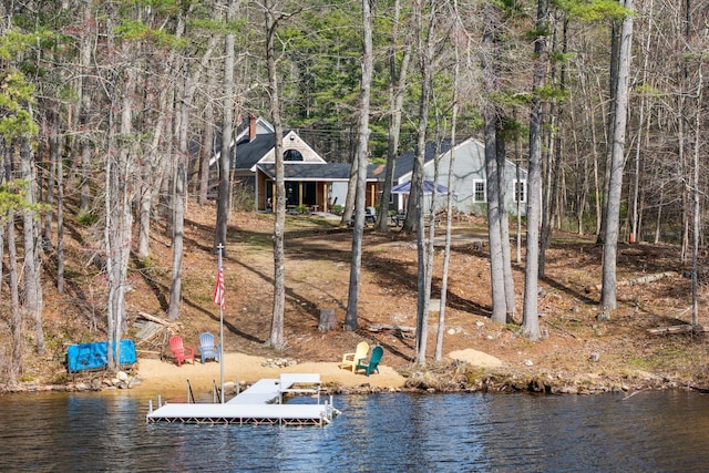 exterior space with a water view and a chimney