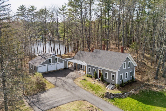 aerial view with a water view and a view of trees