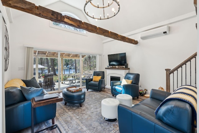 living room featuring a fireplace, a wall mounted AC, beam ceiling, high vaulted ceiling, and a notable chandelier