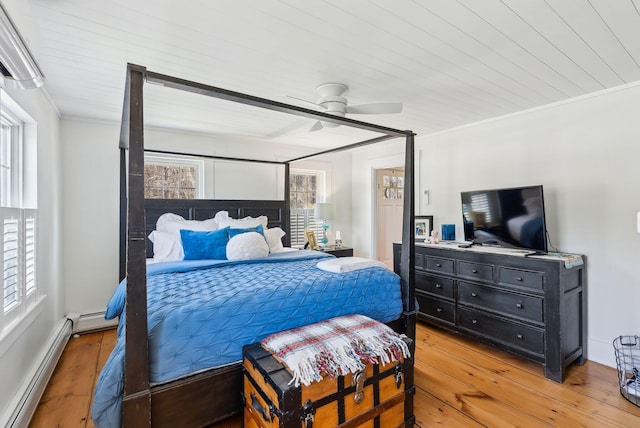bedroom featuring ceiling fan, a baseboard radiator, ornamental molding, and light wood-style flooring