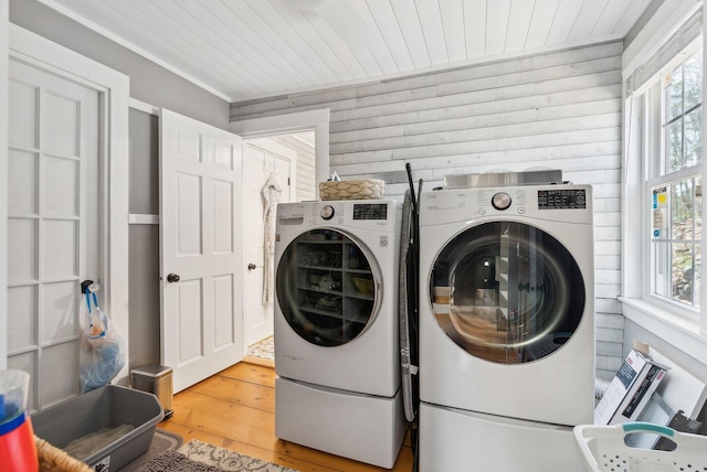 washroom featuring a healthy amount of sunlight, separate washer and dryer, laundry area, and wood finished floors