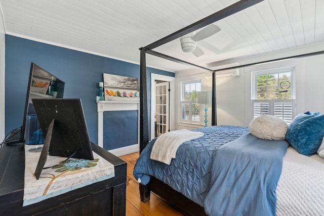 bedroom featuring light wood-style flooring, multiple windows, and wooden ceiling