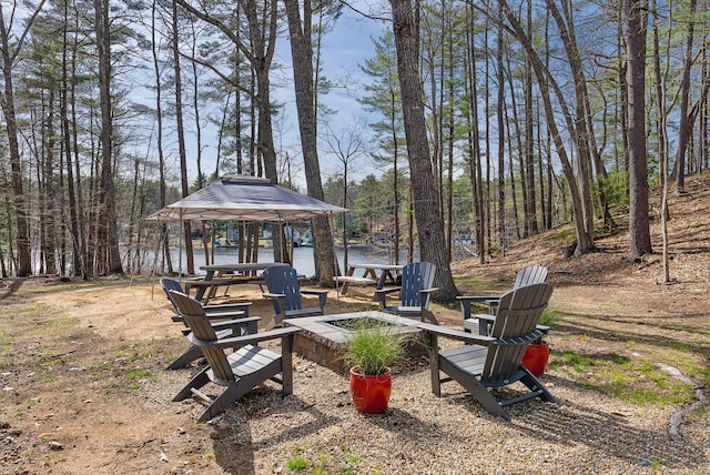 view of yard with a gazebo and an outdoor fire pit
