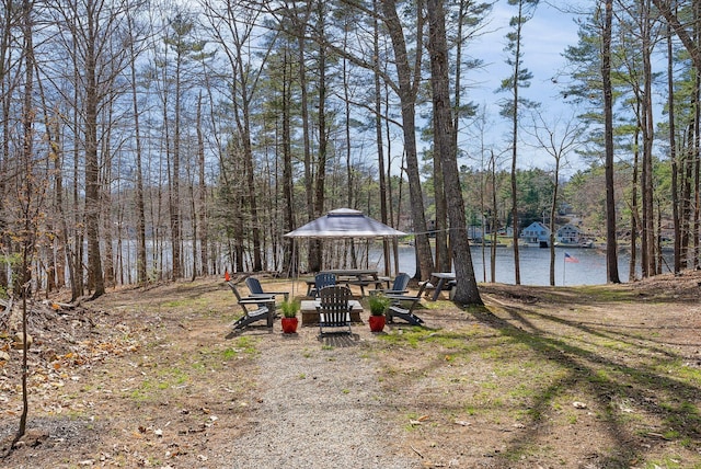 view of yard featuring a water view and a gazebo
