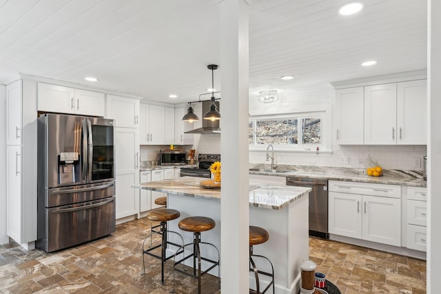 kitchen featuring stainless steel appliances, recessed lighting, white cabinetry, and a sink