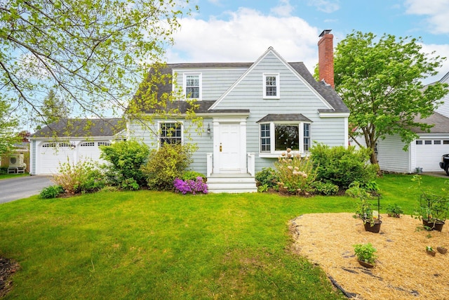 9 Phillips Rd, Falmouth, ME 04105 - view of front of house with a front lawn, roof with shingles, asphalt driveway, a chimney, and a garage