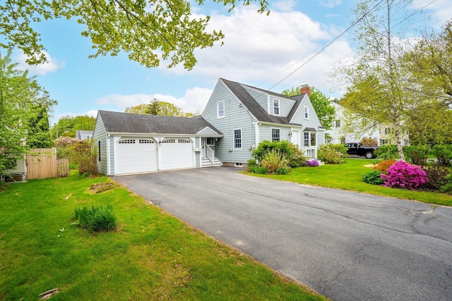 9 Phillips Rd, Falmouth, ME 04105 - view of front of property featuring a garage, asphalt driveway, a chimney, and a shingled roof