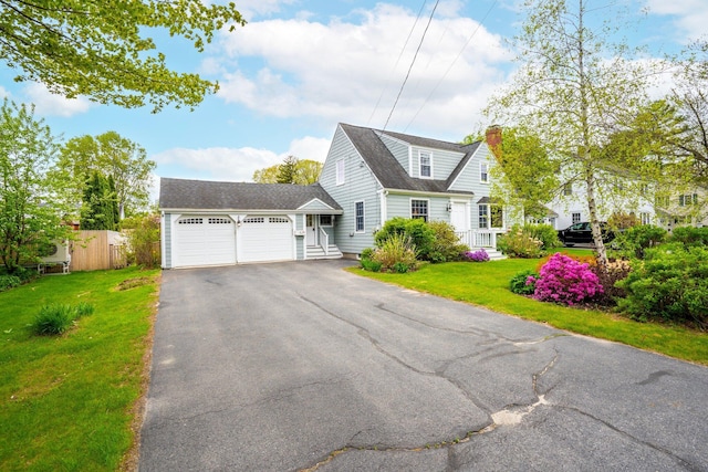 9 Phillips Rd, Falmouth, ME 04105 - view of front of home with a garage, a chimney, and driveway