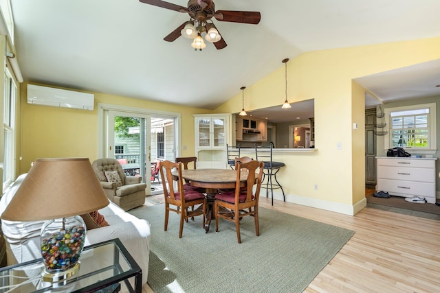9 Phillips Rd, Falmouth, ME 04105 - dining space featuring a wall mounted AC, vaulted ceiling, plenty of natural light, wood finished floors, and ceiling fan