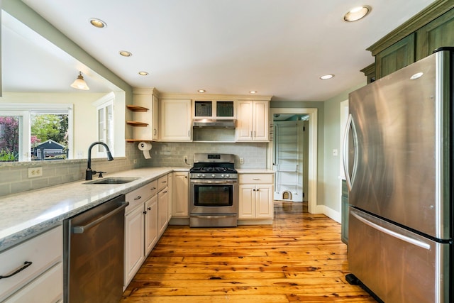 9 Phillips Rd, Falmouth, ME 04105 - kitchen with appliances with stainless steel finishes, a sink, light wood-style floors, decorative backsplash, and recessed lighting