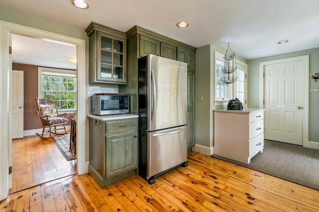 9 Phillips Rd, Falmouth, ME 04105 - kitchen featuring appliances with stainless steel finishes, green cabinetry, light wood-type flooring, recessed lighting, and glass insert cabinets