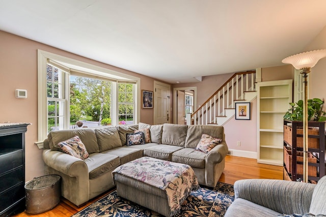 9 Phillips Rd, Falmouth, ME 04105 - living room featuring wood finished floors, stairs, and baseboards