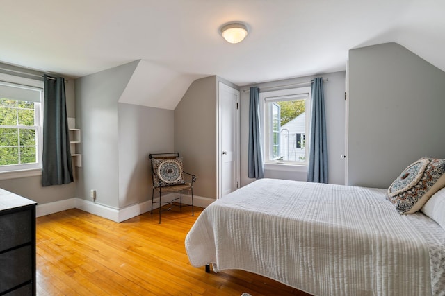 9 Phillips Rd, Falmouth, ME 04105 - bedroom with multiple windows, lofted ceiling, hardwood / wood-style flooring, and baseboards