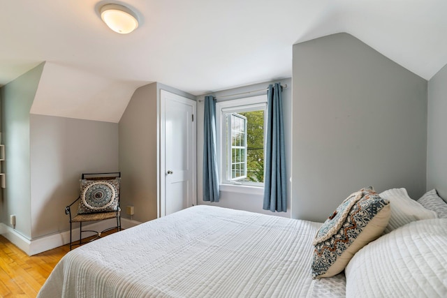 9 Phillips Rd, Falmouth, ME 04105 - bedroom with lofted ceiling, light wood finished floors, and baseboards