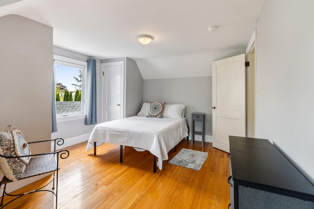 9 Phillips Rd, Falmouth, ME 04105 - bedroom with lofted ceiling, light wood-style floors, and baseboards