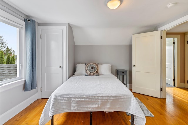 9 Phillips Rd, Falmouth, ME 04105 - bedroom featuring light wood-style flooring, baseboards, and vaulted ceiling
