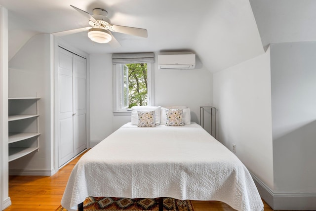 9 Phillips Rd, Falmouth, ME 04105 - bedroom featuring an AC wall unit, light wood-type flooring, ceiling fan, a closet, and baseboards