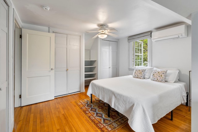 9 Phillips Rd, Falmouth, ME 04105 - bedroom featuring a wall mounted AC, two closets, light wood-style floors, and a ceiling fan