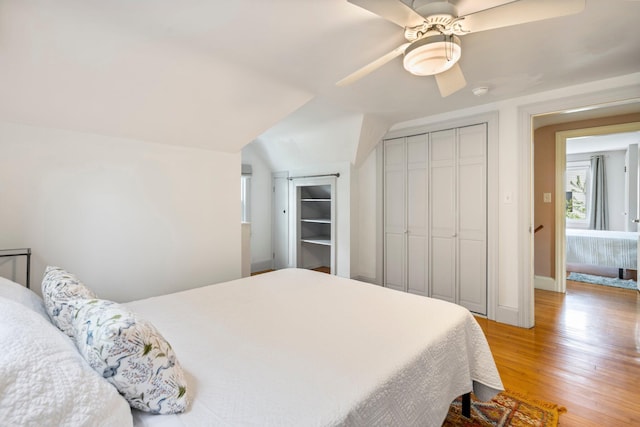 9 Phillips Rd, Falmouth, ME 04105 - bedroom with light wood-style floors, vaulted ceiling, ceiling fan, a closet, and baseboards