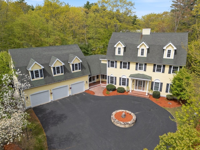 6 Jason Ln, Ogunquit, ME 03907 - view of front facade with driveway, a garage, and a chimney