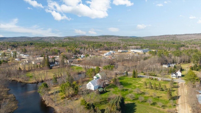 aerial view with a water view and a forest view