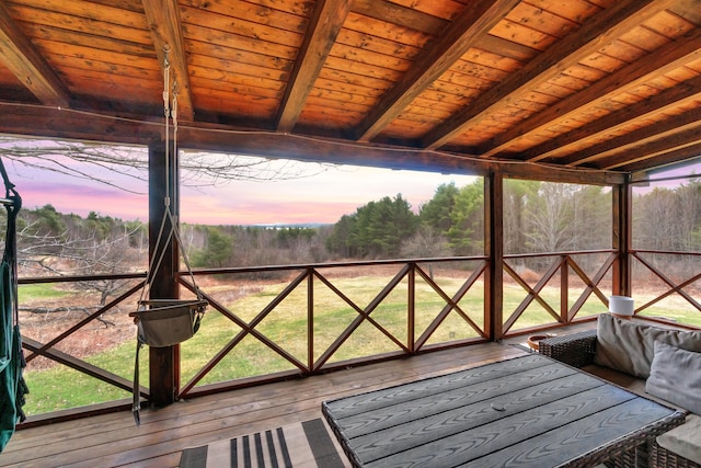 sunroom featuring beamed ceiling