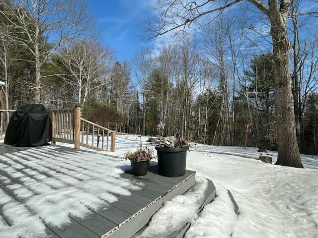 snow covered deck featuring a grill