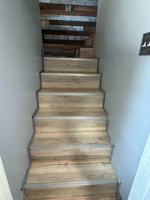 stairway featuring baseboards
