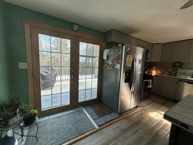 doorway with light wood-style floors and french doors