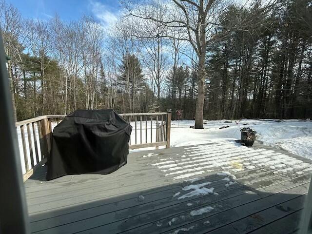 snow covered deck featuring a grill
