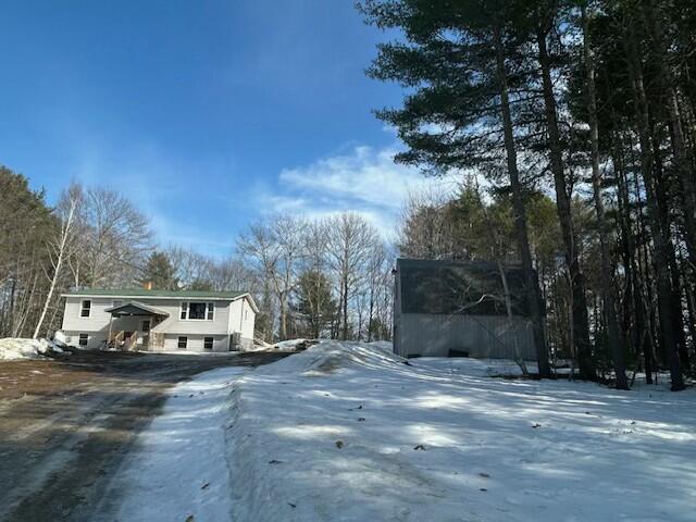 view of street with dirt driveway
