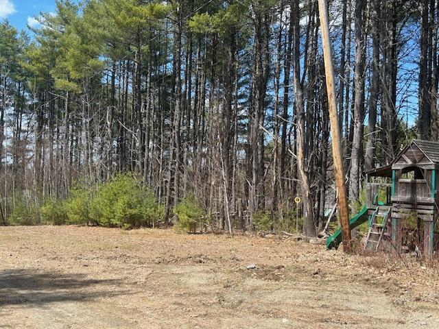 69 Goulds Ridge Rd, Passadumkeag, ME 04475 - view of yard with a playground and a forest view