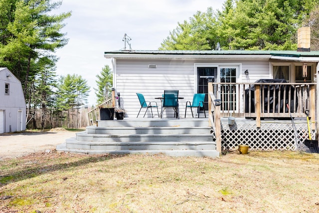 69 Goulds Ridge Rd, Passadumkeag, ME 04475 - back of house featuring stairs, a deck, and metal roof