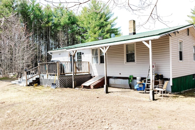 69 Goulds Ridge Rd, Passadumkeag, ME 04475 - rear view of property with metal roof and a deck