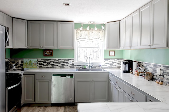 69 Goulds Ridge Rd, Passadumkeag, ME 04475 - kitchen featuring stainless steel dishwasher, a sink, range, gray cabinetry, and light countertops
