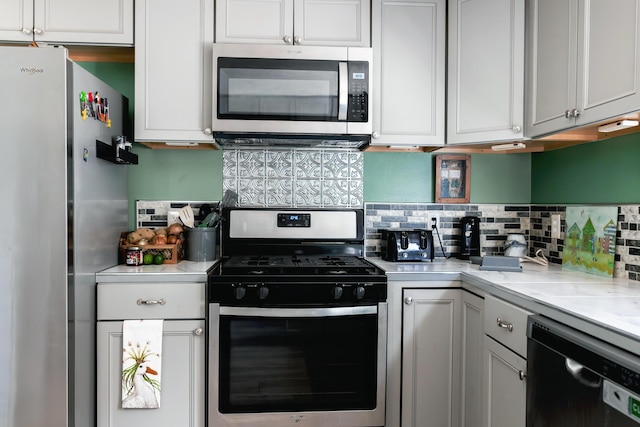 69 Goulds Ridge Rd, Passadumkeag, ME 04475 - kitchen featuring appliances with stainless steel finishes, tasteful backsplash, and white cabinets