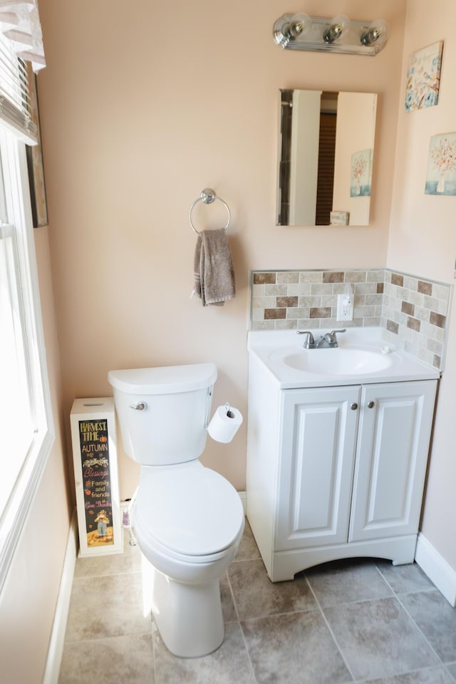 69 Goulds Ridge Rd, Passadumkeag, ME 04475 - bathroom featuring toilet, vanity, backsplash, and tile patterned flooring