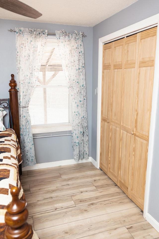 69 Goulds Ridge Rd, Passadumkeag, ME 04475 - unfurnished bedroom featuring light wood-style floors, baseboards, and a closet