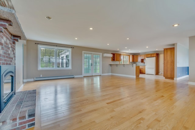 30 Apple Hill Vw, Alfred, ME 04002 - unfurnished living room with a baseboard radiator, a fireplace, light wood-style flooring, recessed lighting, and baseboards