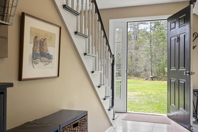 tiled entrance foyer featuring stairs