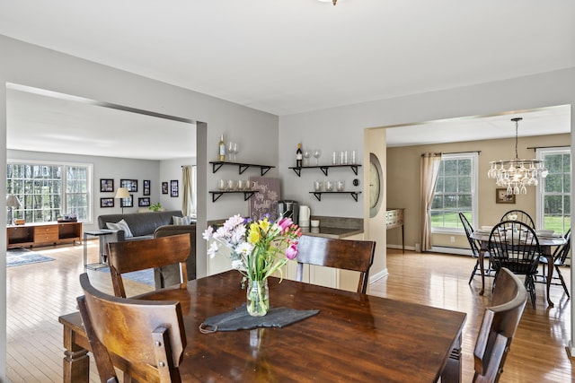dining room featuring light wood-style floors and a chandelier