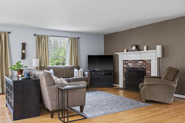 living area featuring light wood-style floors and a fireplace
