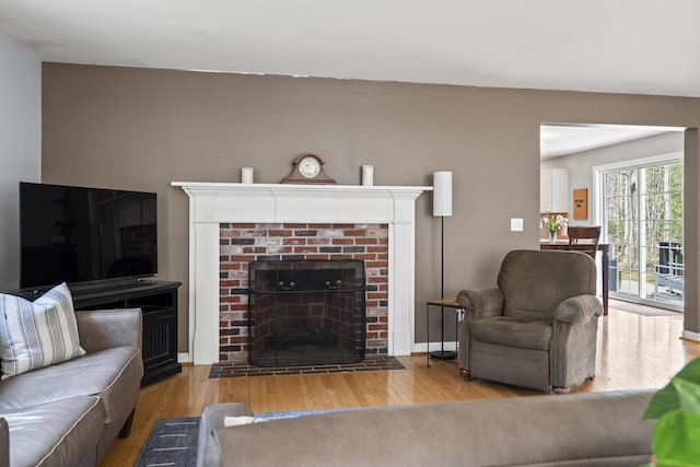 living area with hardwood / wood-style floors and a fireplace