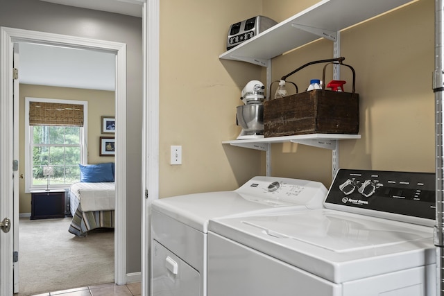 laundry room with light colored carpet, separate washer and dryer, light tile patterned flooring, and baseboards